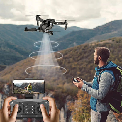 Person controlling a drone with a scenic background