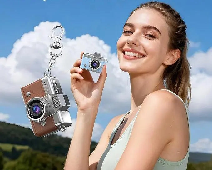 Woman holding mini keychain camera outdoors with close-up of brown retro design camera keychain